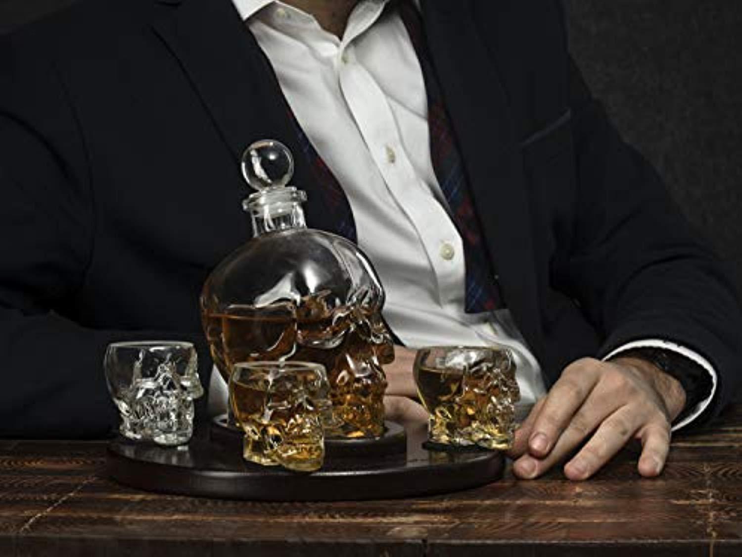 Guzzle Buddy Large Skull Face Decanter with 4 Skull Shot Glasses and Beautiful Wooden Base - By The Wine Savant Use Skull Head Cup For A Whiskey, Scotch and Vodka Shot Glass, 25 Ounce Decanter 3 Ounces Shot Glass